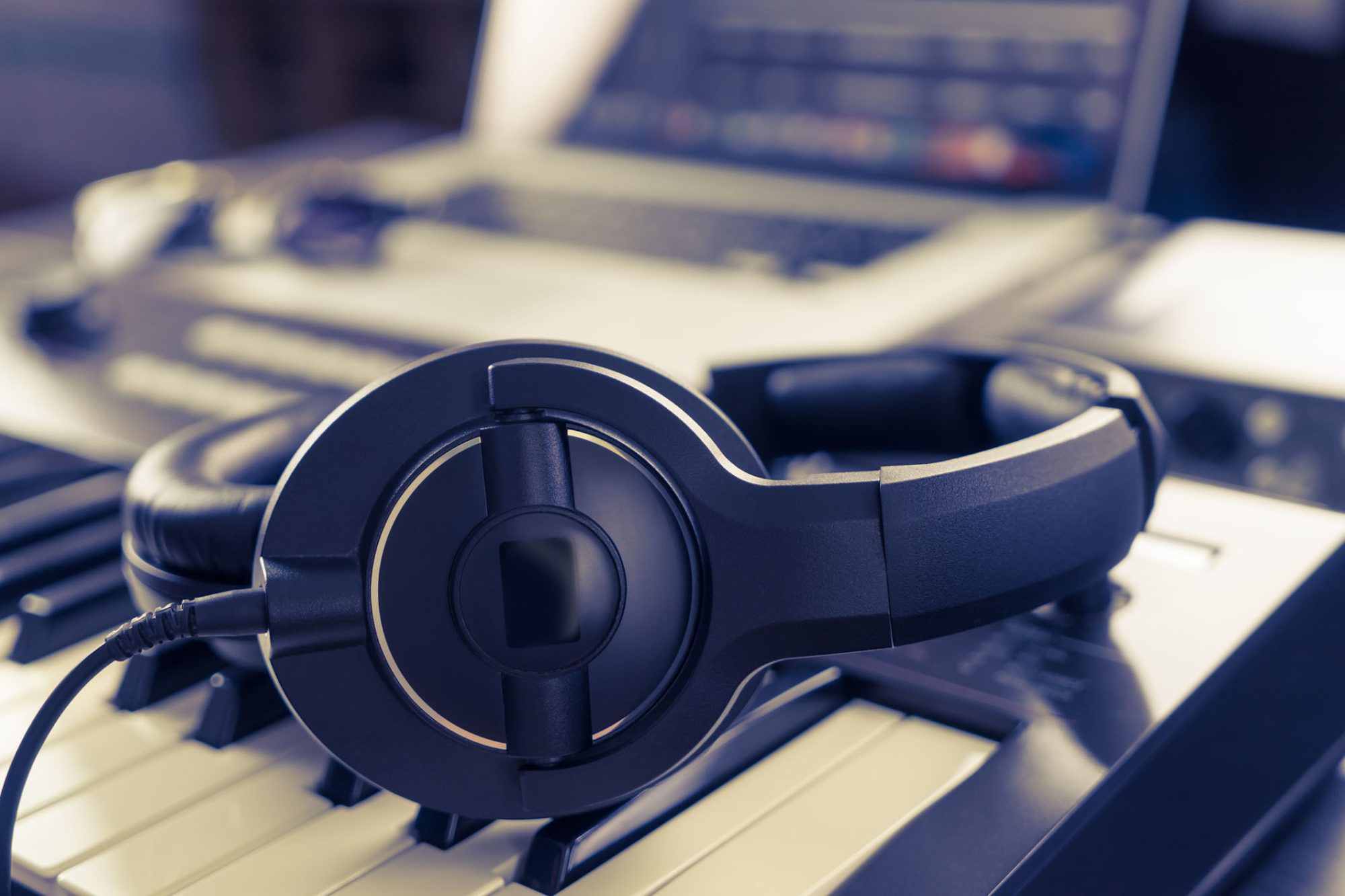 Black headphone on computer music home studio set up